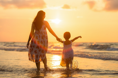 Mom & Child walking in beach sunset